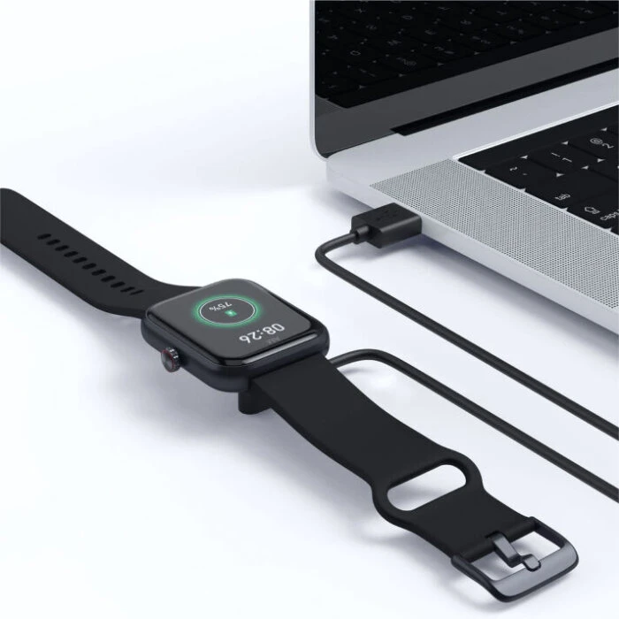 FitiWatch connected to magnetic charging connector setup on table